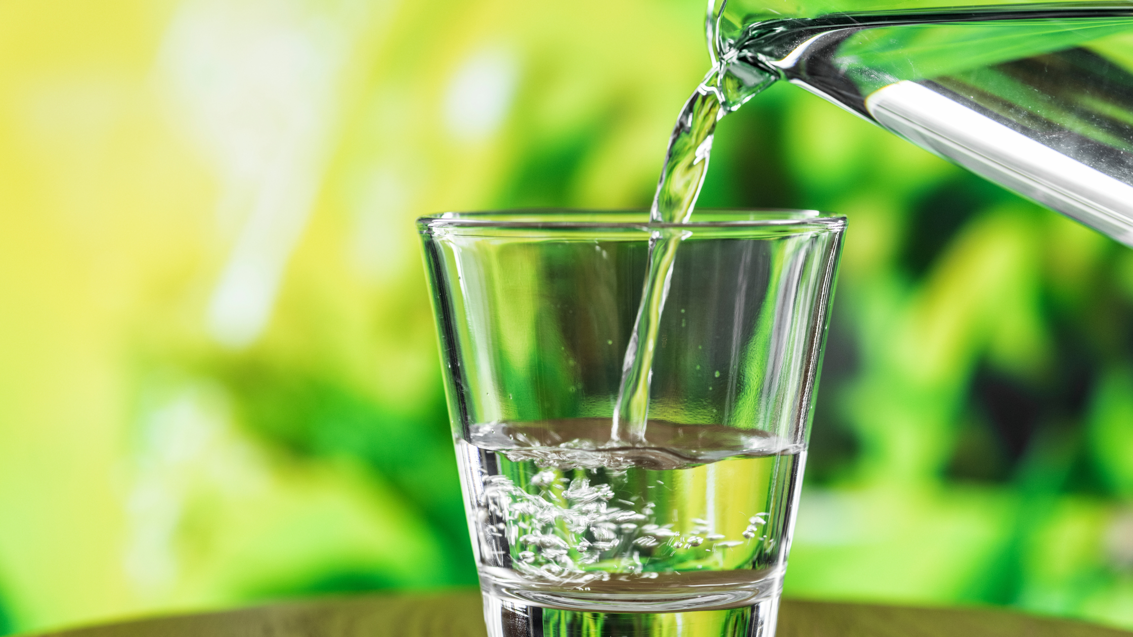 image of water pouring into the glass using as a blog banner image for How Much Water Should You Drink Per Day in India blog